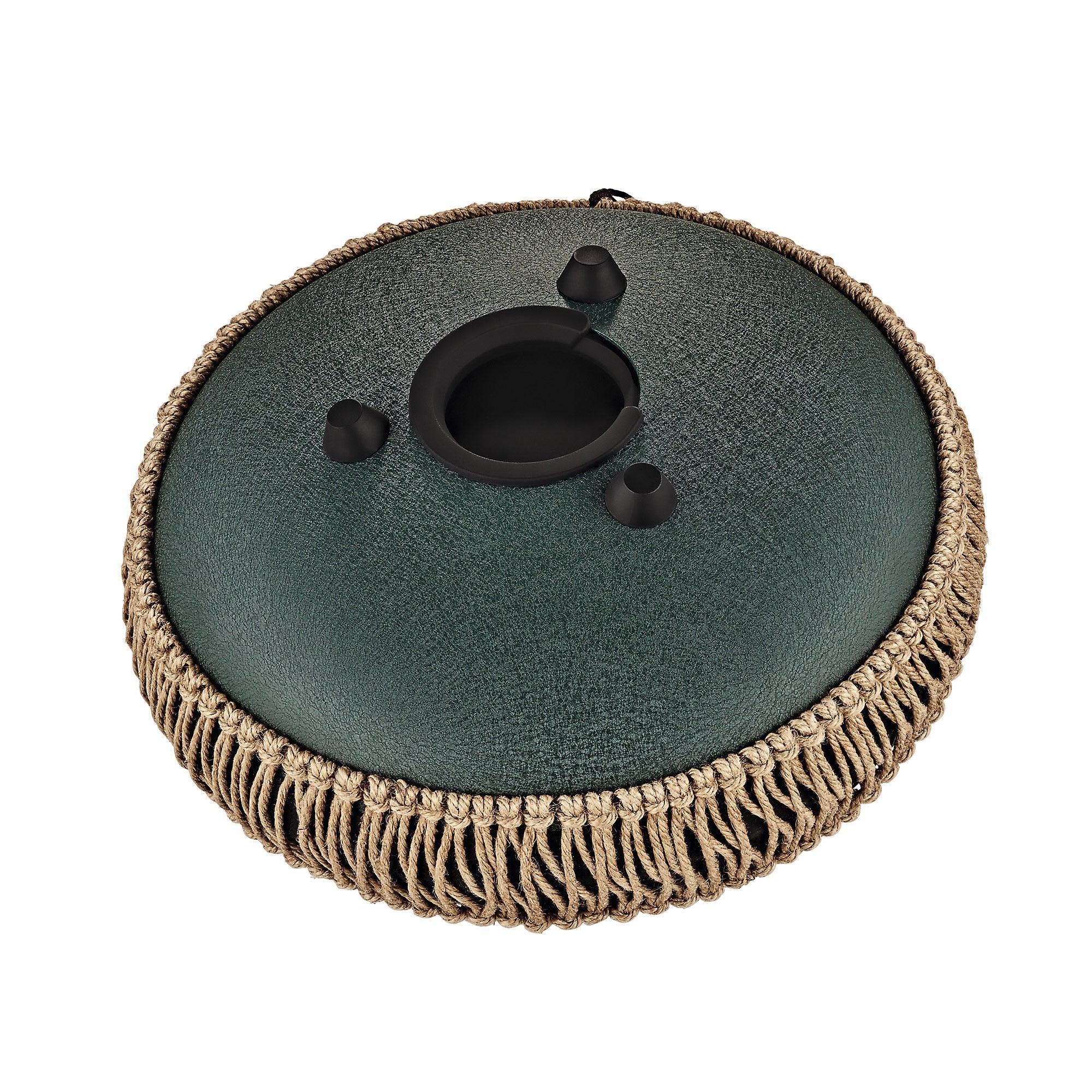 Steel tongue drum with green textured surface, woven rope trim, and circular sound holes