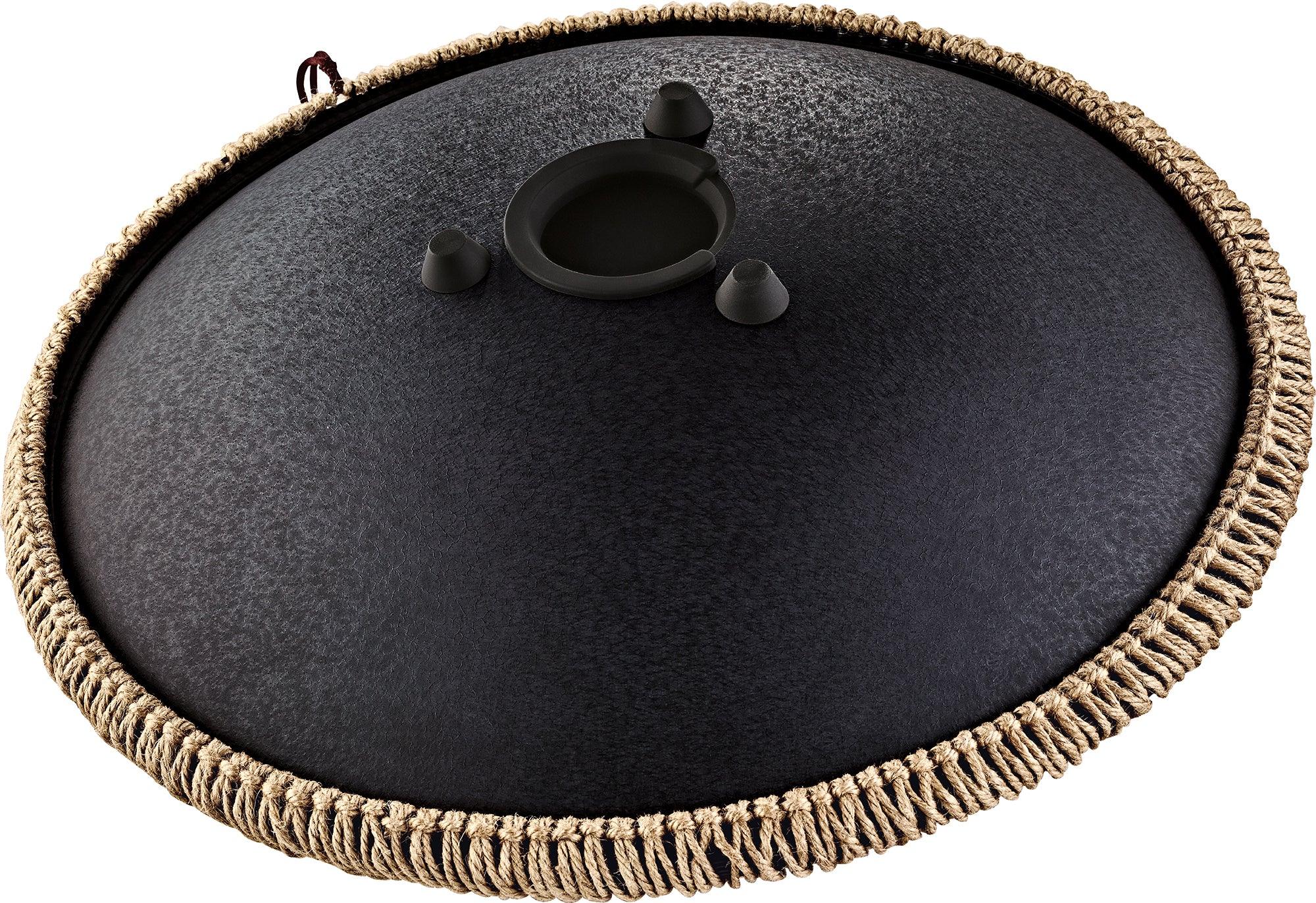 Black steel tongue drum with textured finish, rope trim, and padded feet for sound healing