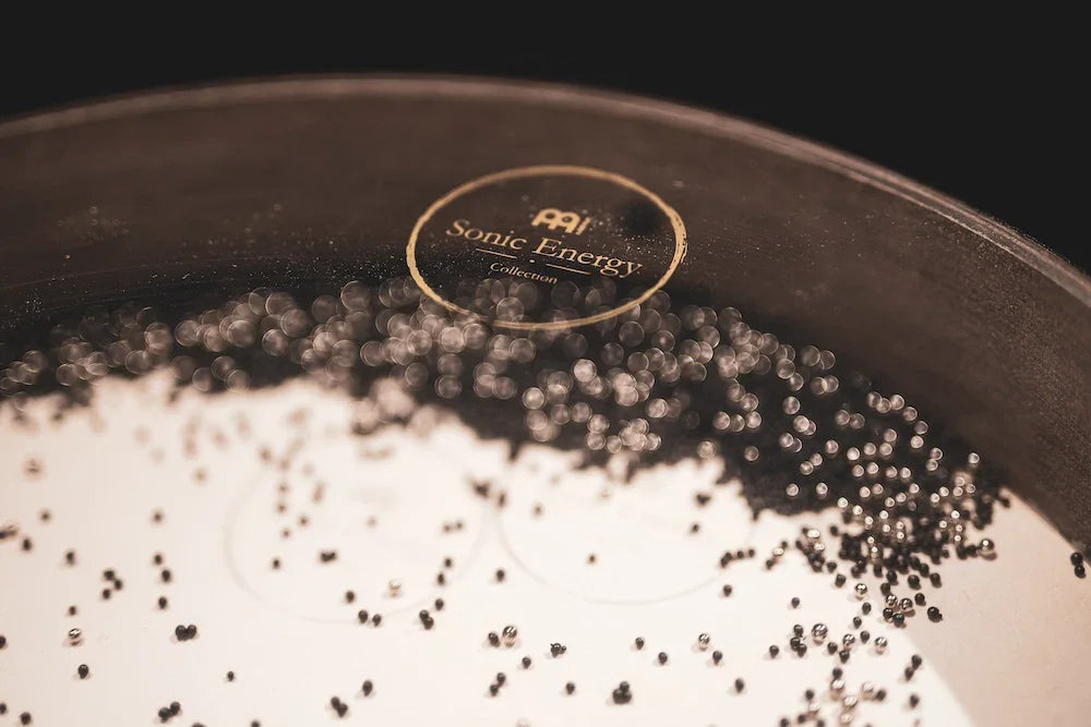 Close-up of Sonic Energy metal singing bowl with black granules for sound healing