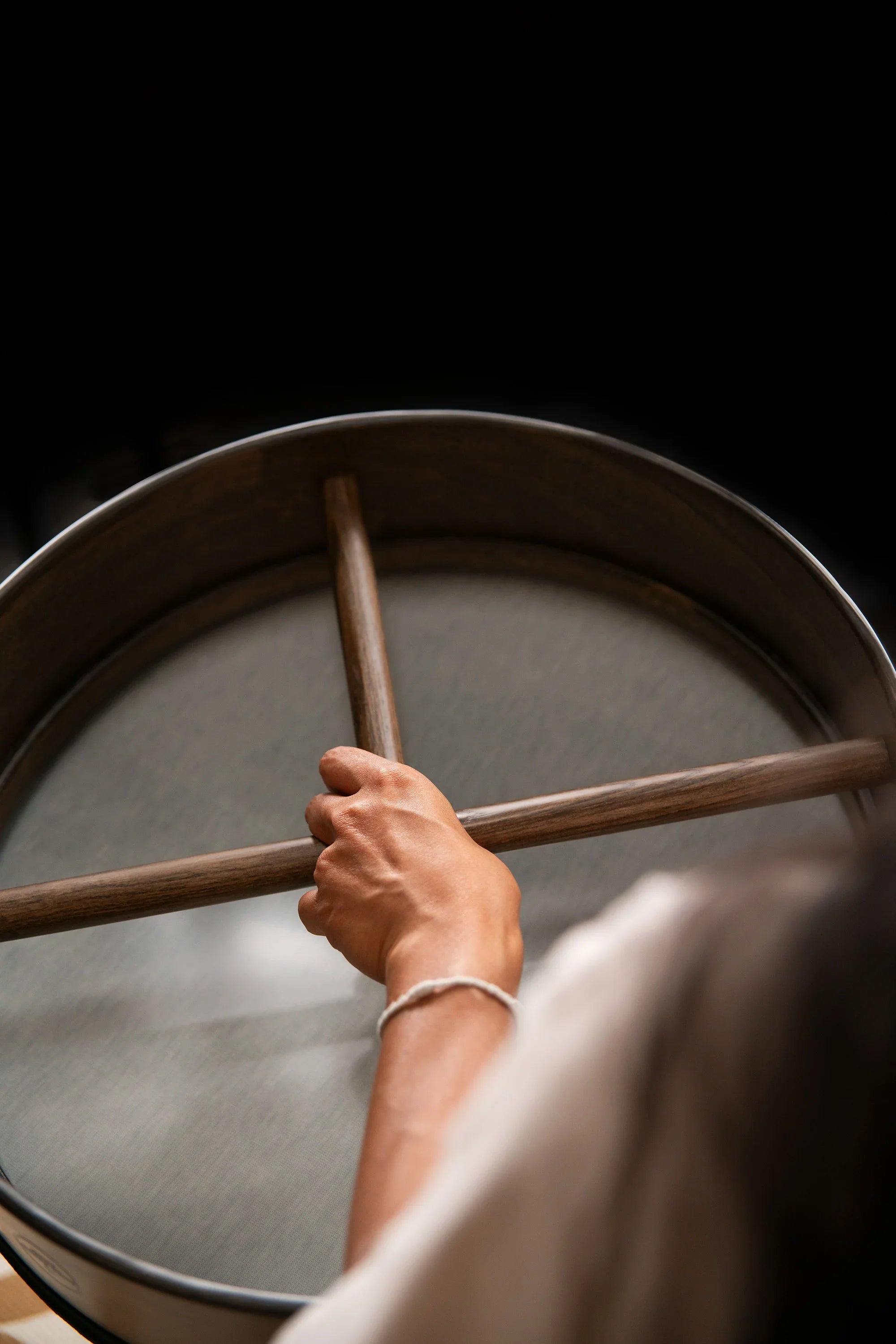 Hand holding frame drum for sound healing and meditation