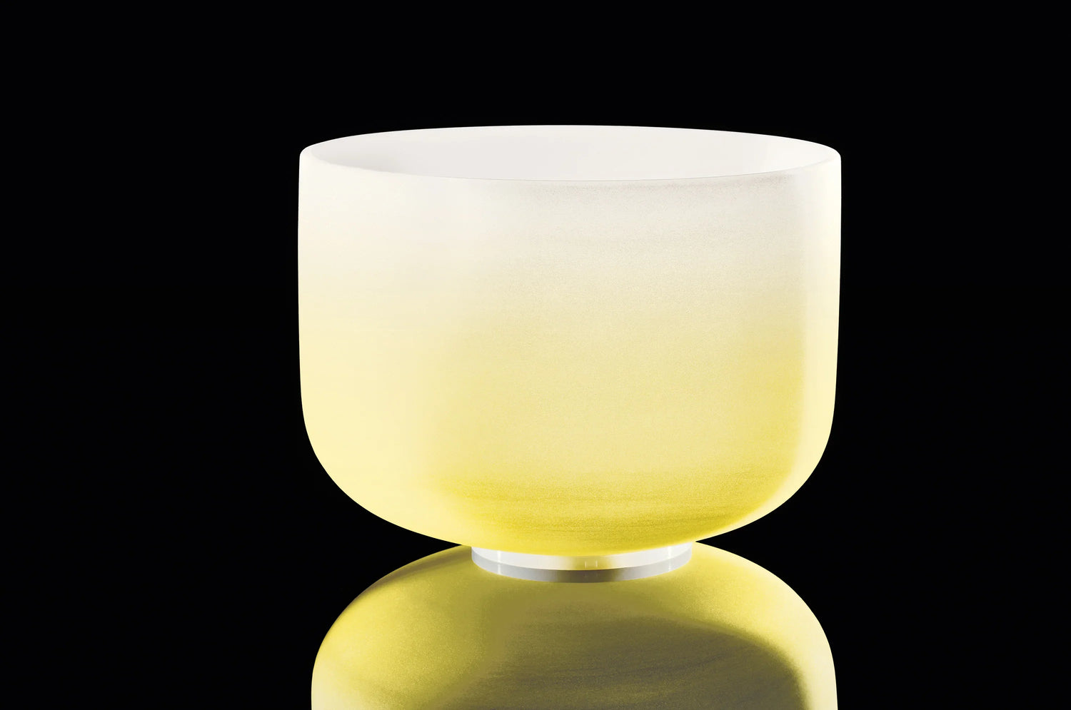 Yellow crystal singing bowl for sound healing on black background