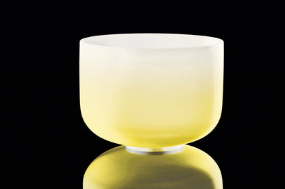 Yellow crystal singing bowl for sound healing on black background