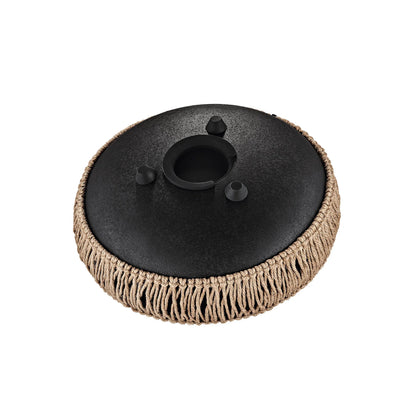 Black metal handpan drum with tan rope accent for sound healing, isolated on white background.