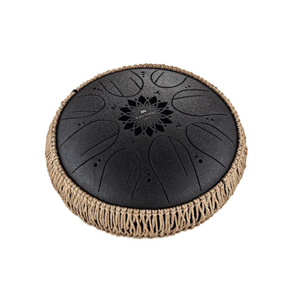 Black steel tongue drum with rope trim for sound healing and meditation on white background
