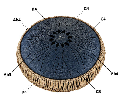 Black tongue drum with note labels, decorative rope edge, and etched flower pattern top