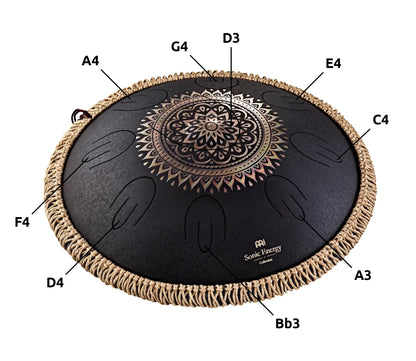 Decorative steel tongue drum with engraved mandala, labeled musical notes, for sound healing