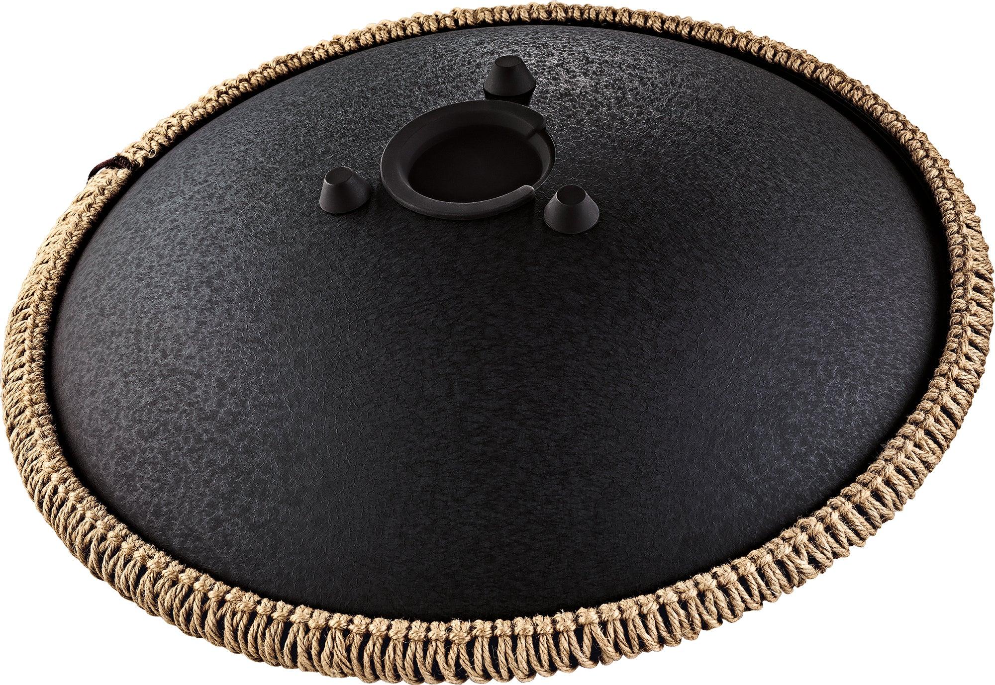 Black steel tongue drum with textured finish and braided rope edge, top view