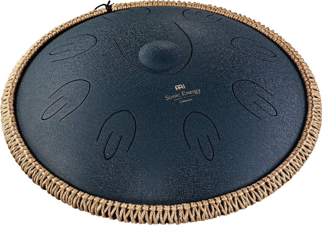Steel tongue drum with engraved notes and woven rope edge for sound healing or meditation.