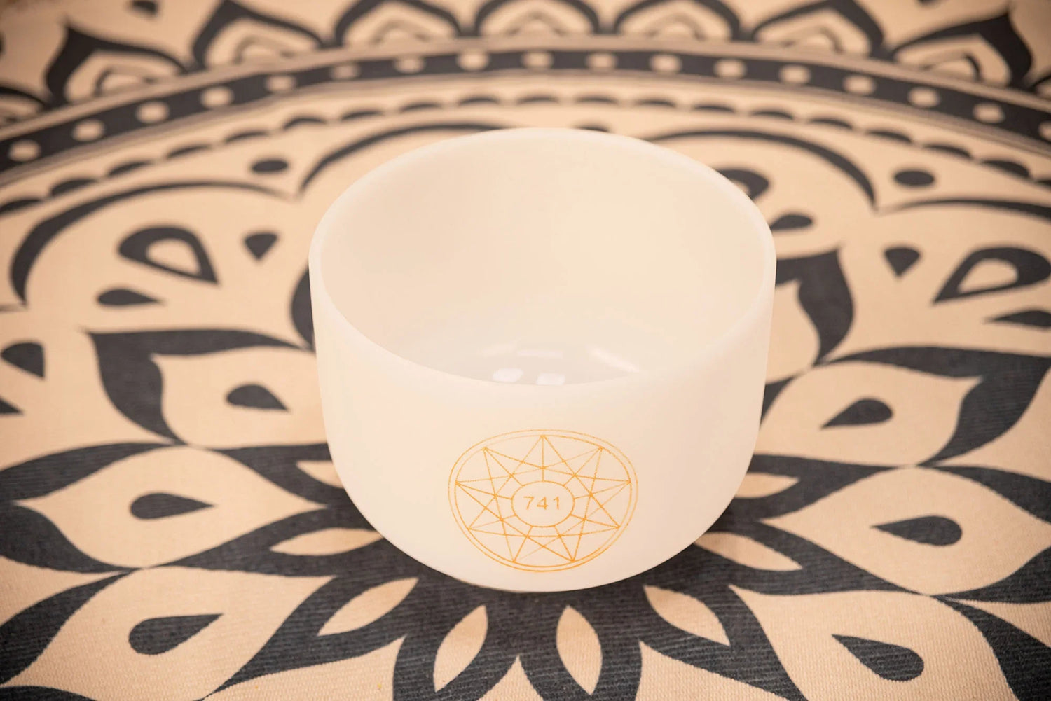 Crystal singing bowl with 741 Hz symbol on a patterned mat, for sound healing and meditation