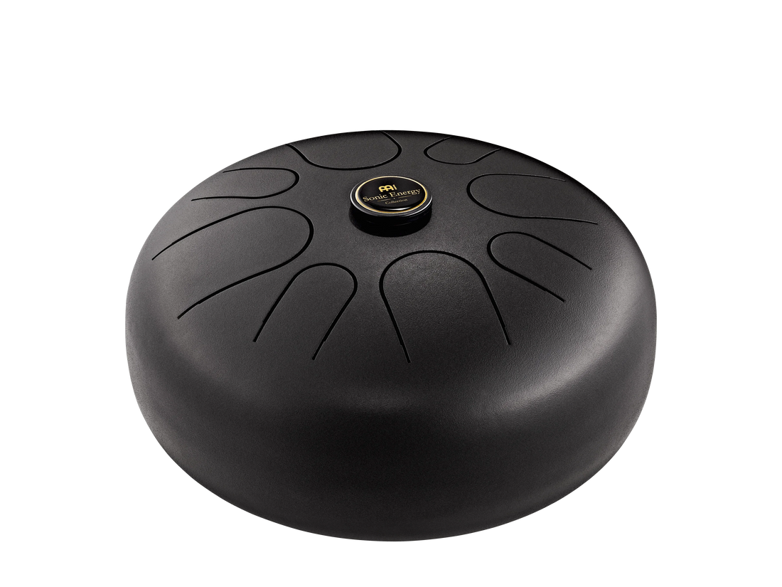 Black steel tongue drum for sound healing and meditation, isolated on white background