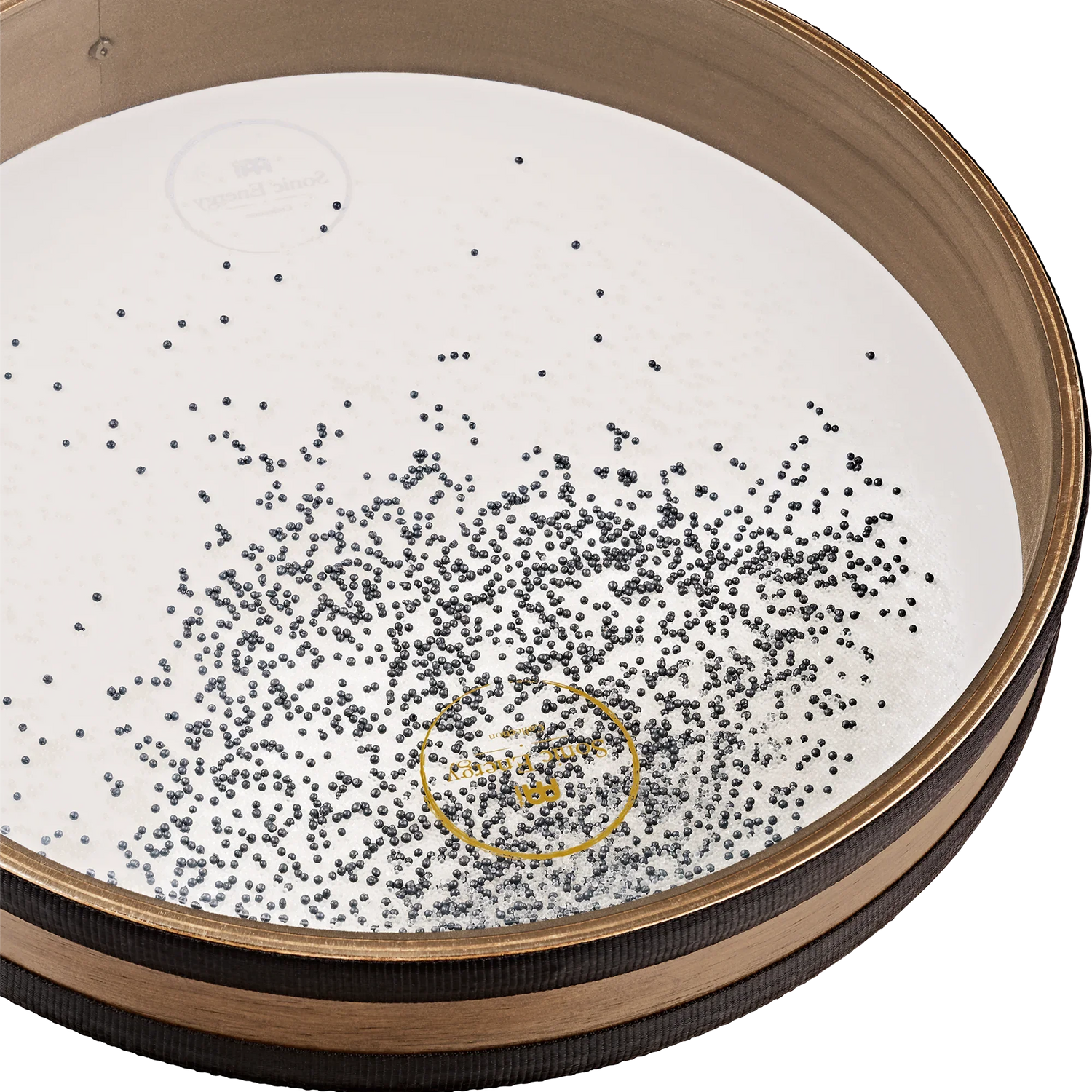 Close-up of a wooden frame drum with metal beads on a white drumhead, used for sound healing.