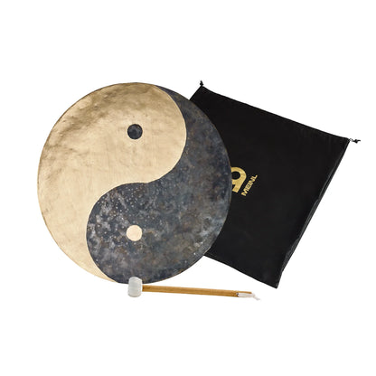 Yin yang gong with mallet and carrying bag, sound healing instrument on white background.