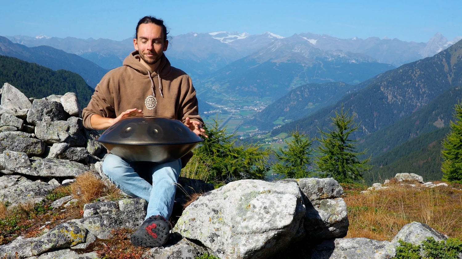 A sound healer playing a handpan in nature that he bought from Utah Energy Healing Center in Bountiful, Utah
